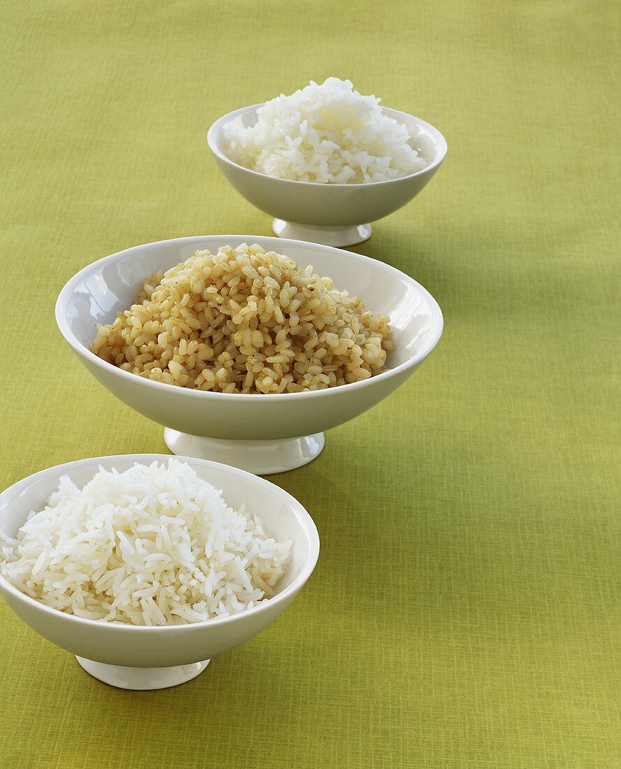 Three different kinds of rice in separate bowls