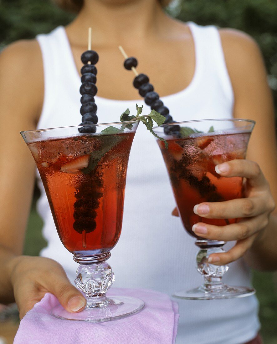 Two summery drinks with berries