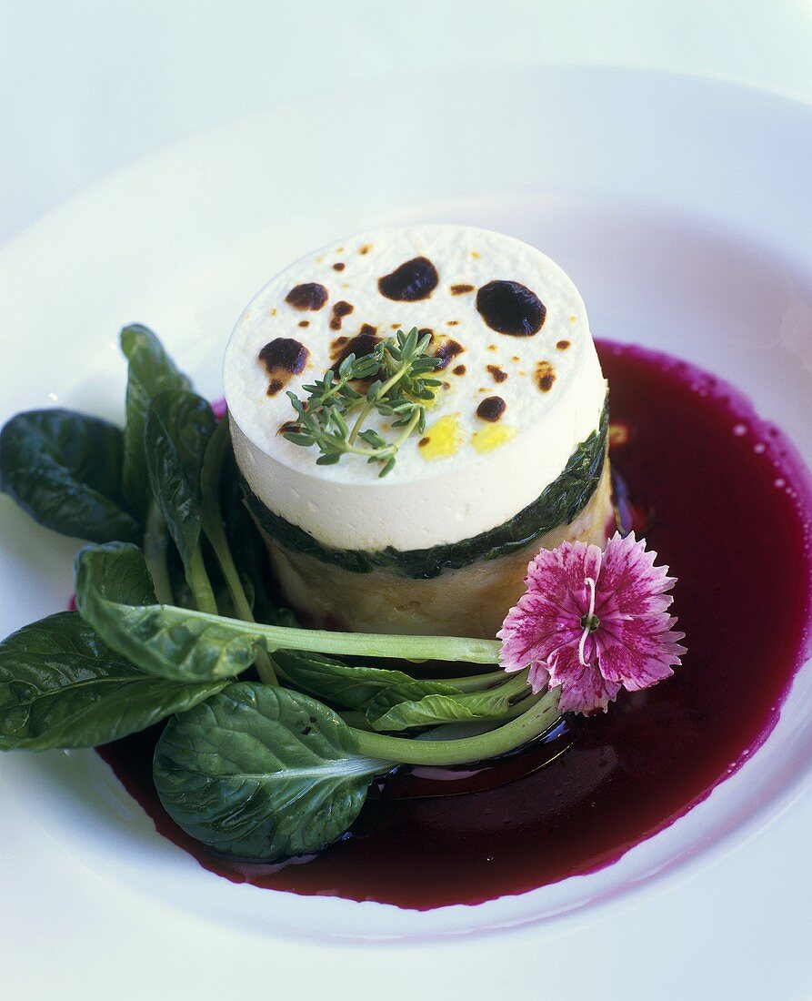 Goat's cheese and spinach cake on beetroot sauce