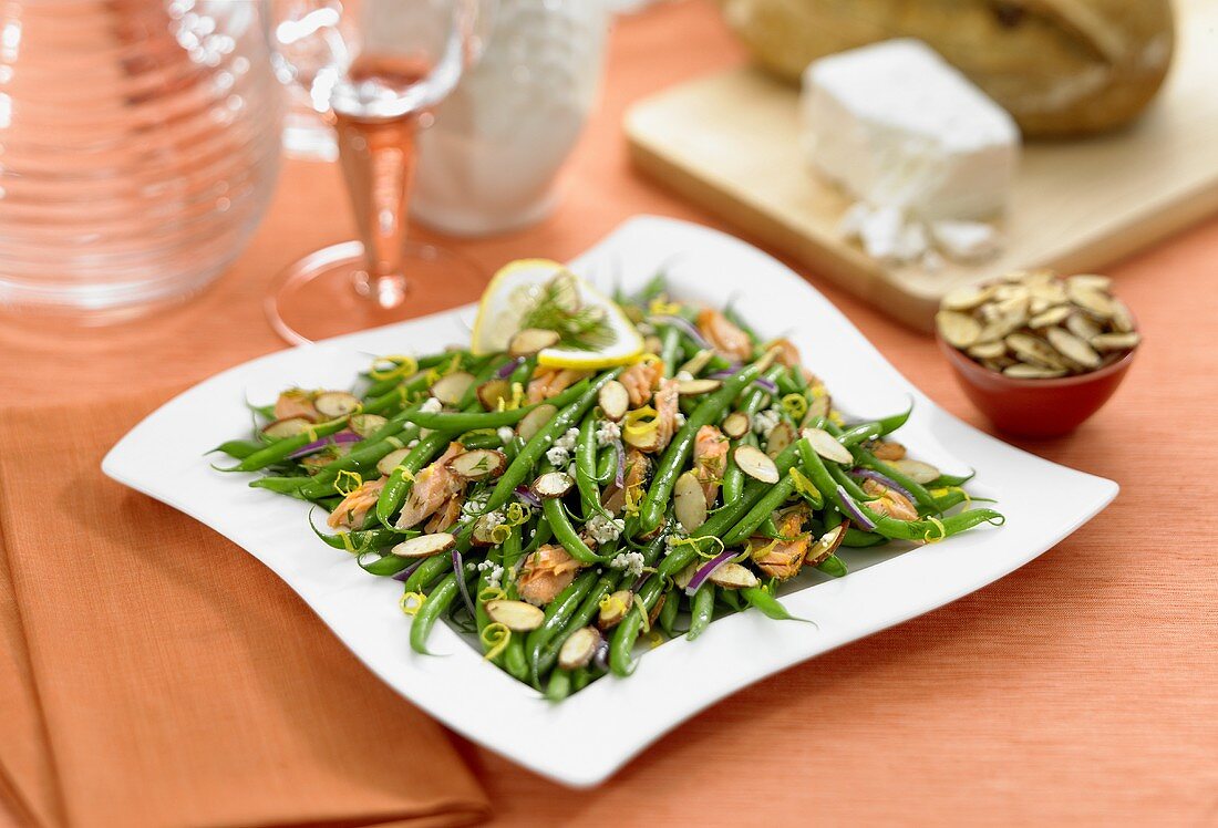 Chicken and Green Bean Salad with Sliced Almonds on a White Plate, Small Bowl of Sliced Almonds