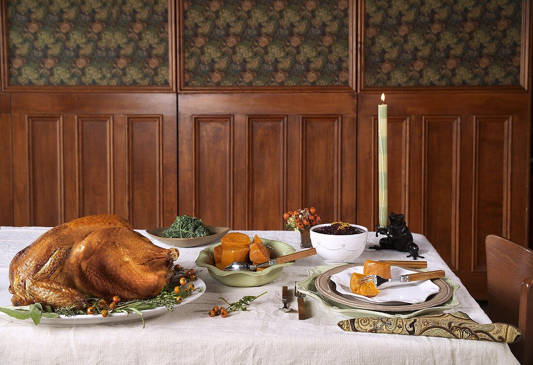 Roast Turkey on a Platter on a Table with Side Dishes, Place Setting