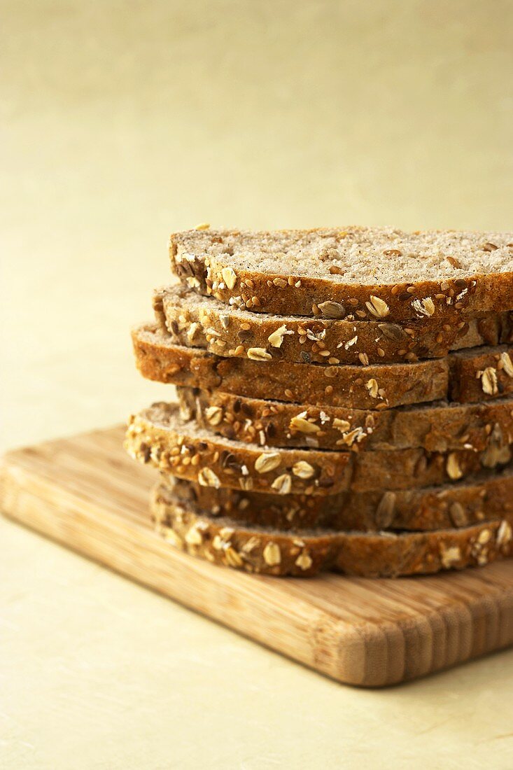 Slices of Multi-Grain Bread Stacked on a Cutting Board