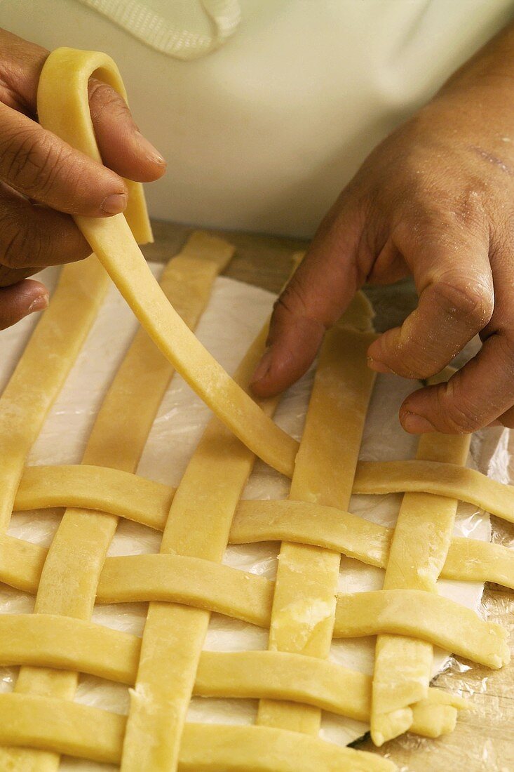 Hands Making a Lattice Pie Crust