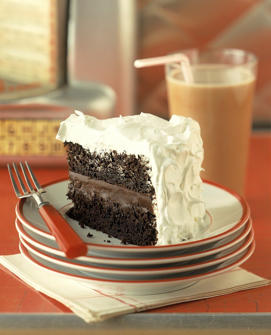 A Piece of Chocolate Cake with White Frosting