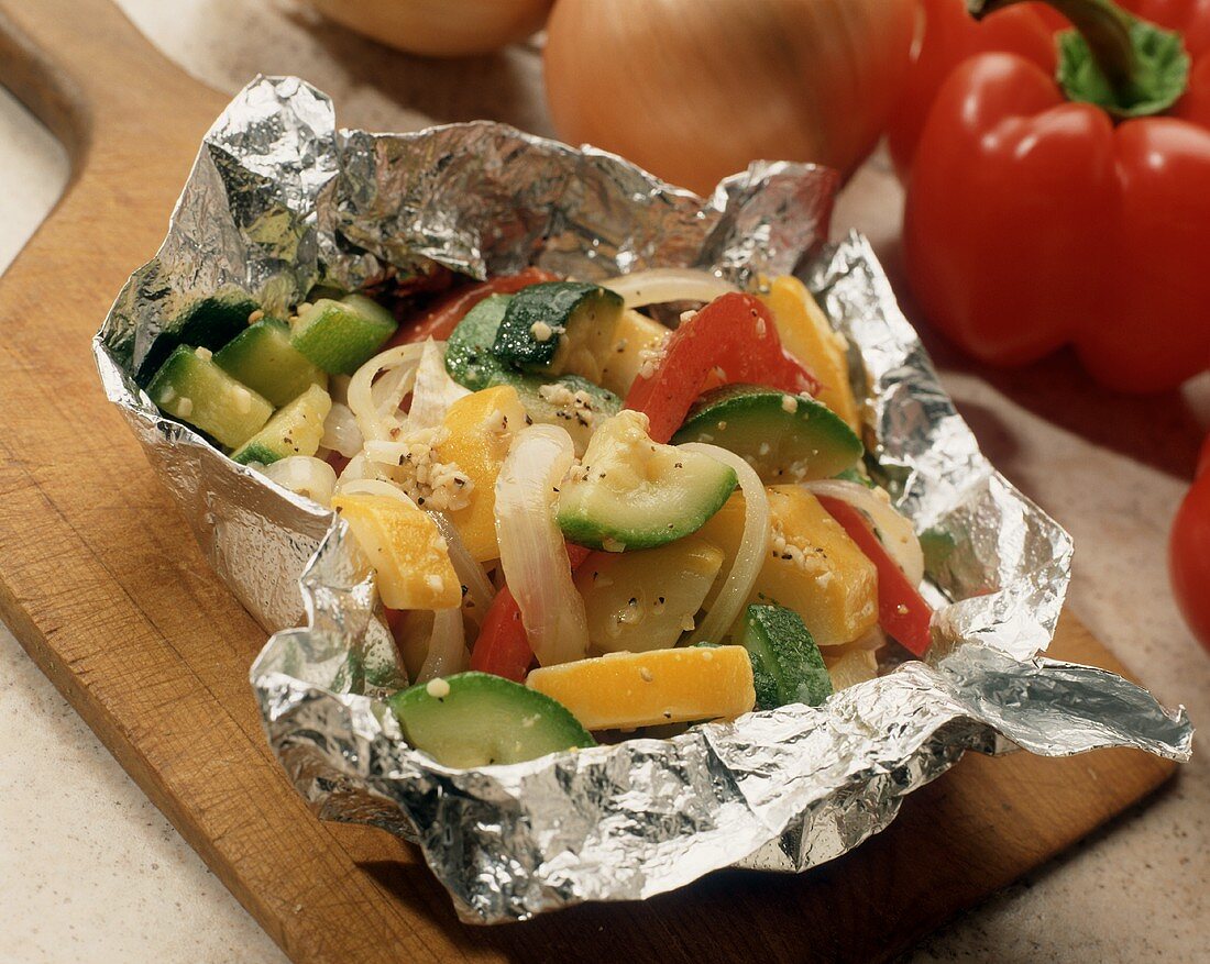 Grilled Vegetables in Foil Packet on a Wooden Board