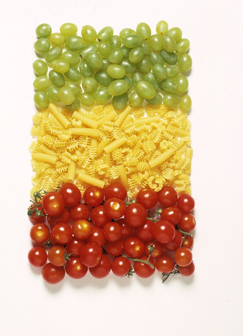 Mixed Still Life: Italian Flag made of Cherry Tomatoes, Dried Pasta and Grapes