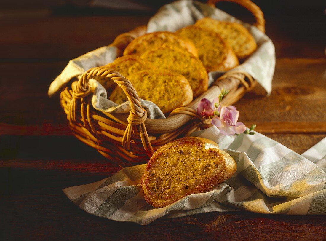 Basket of Garlic Bread with a Slice Resting on Cloth