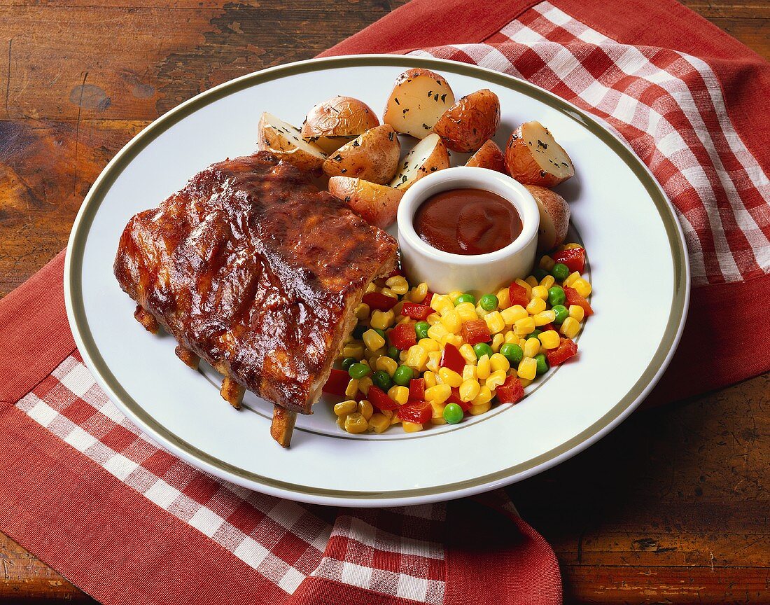 Spareribs mit roten Kartoffeln, Mais und Grillsauce