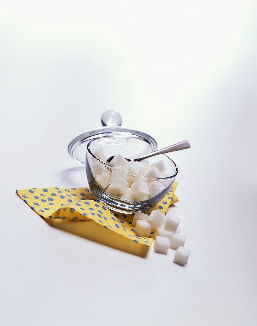 Bowl of White Sugar Cubes Resting on a Napkin