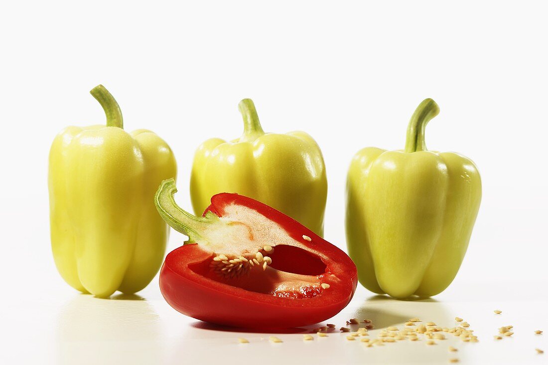 Yellow Peppers with a Half of a Red Pepper with Seeds