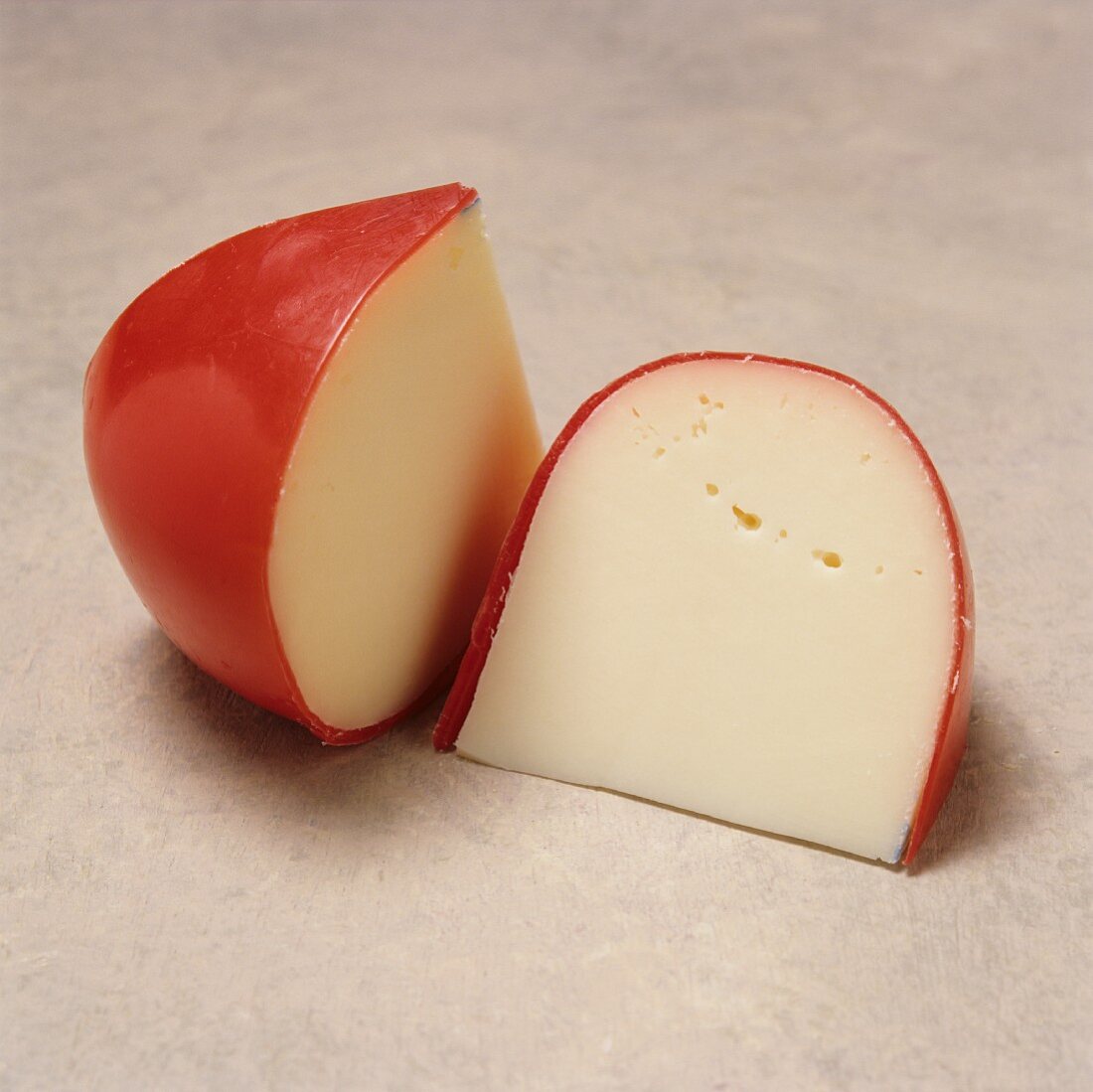 Two Wedges of Baby Gouda Cheese with Red Wax