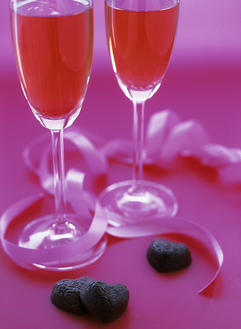 Two Glasses of Pink Champagne with Chocolate Hearts