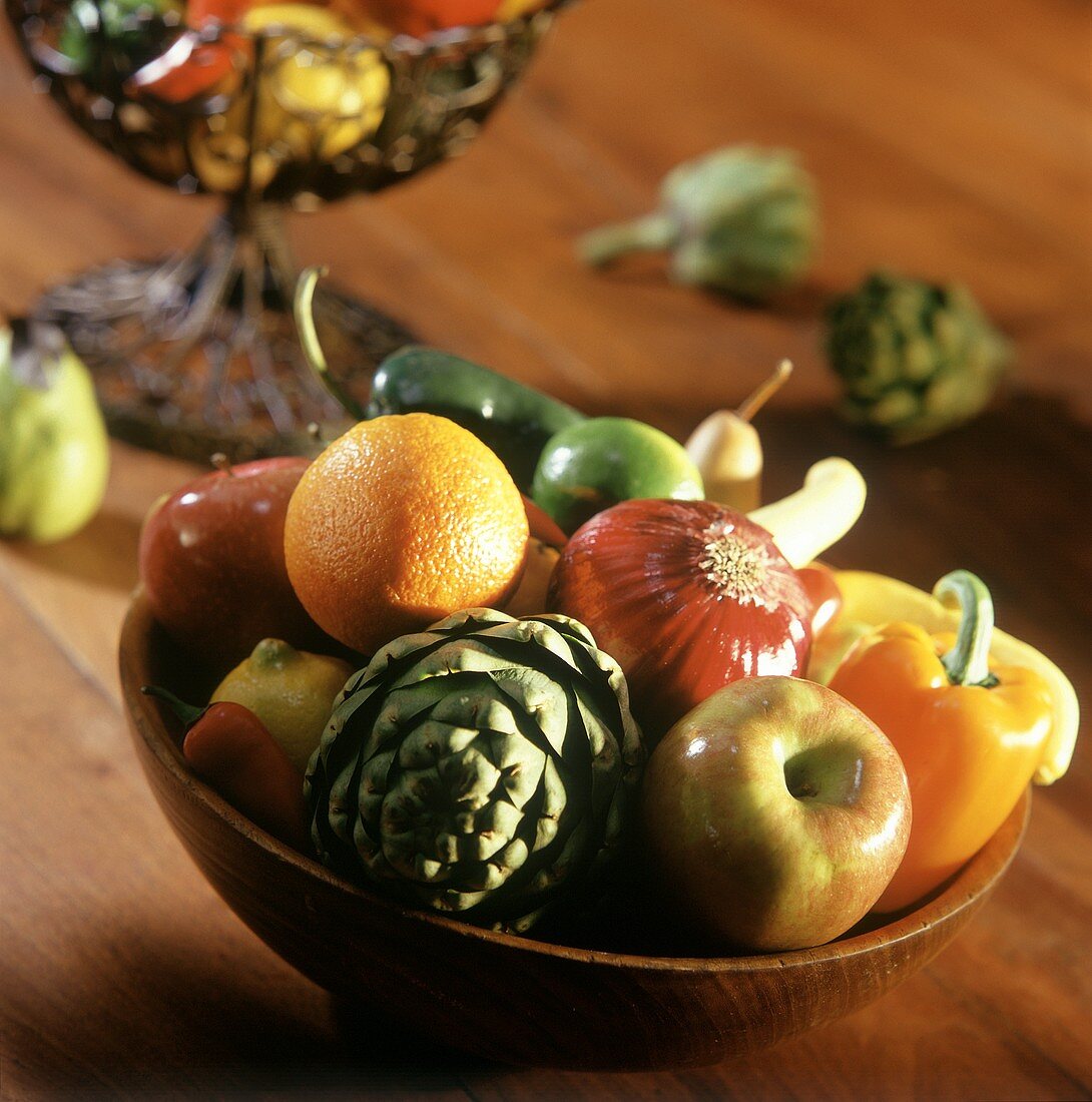 Fresh vegetables and fruit in wooden bowl