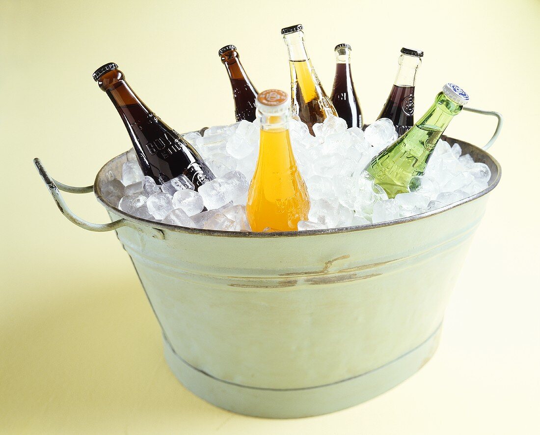 Assorted Soda Bottles in an Ice Bucket