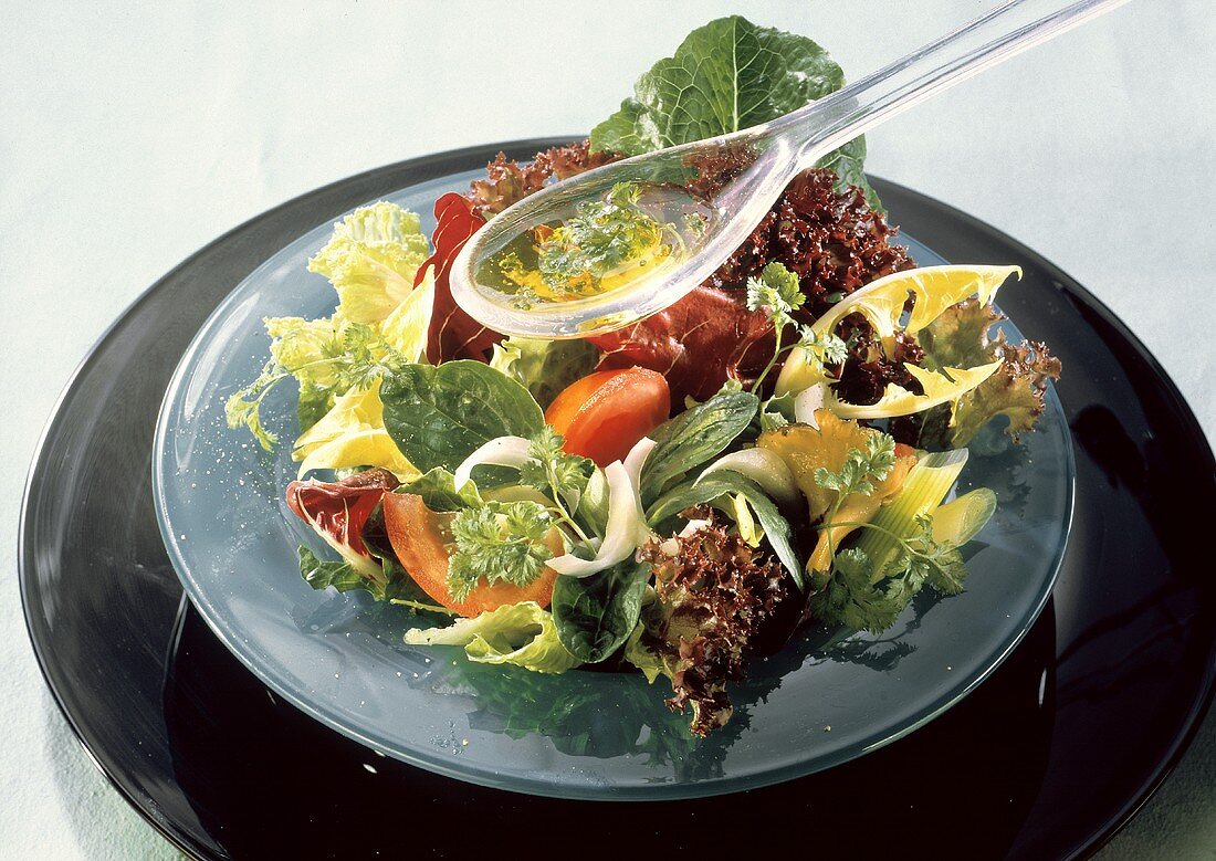 Mixed Greens Salad with Dressing in Plastic Spoon