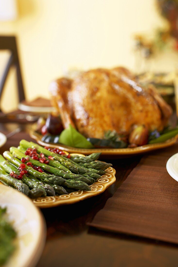 Platter of Asparagus on Table with Roasted Turkey for Thanksgiving