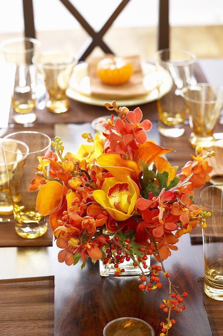 Centerpiece of Autumn Flowers on Thanksgiving Dining Table