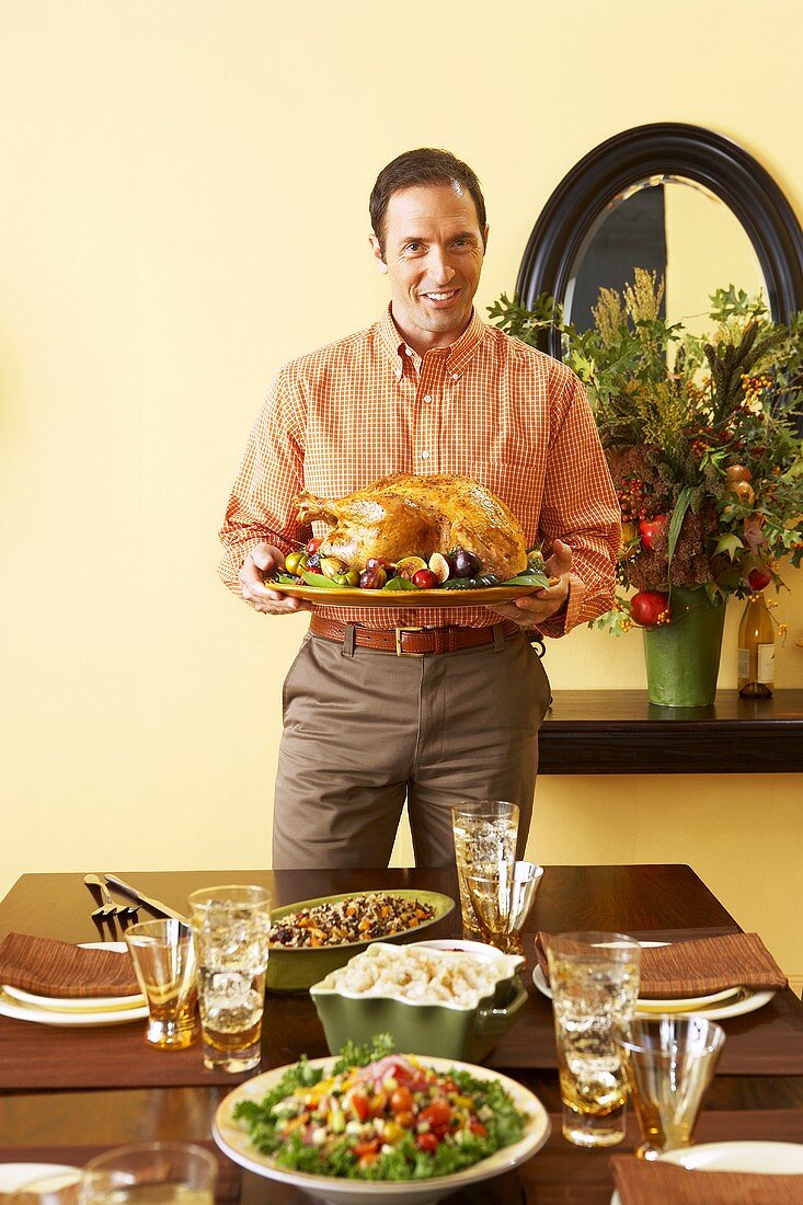 Man Holding Platter with Roasted Thanksgiving Turkey