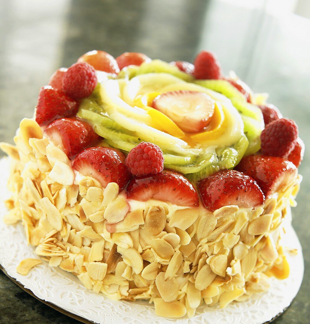 Whole Cake with Slivered Almonds Topped with Fruit