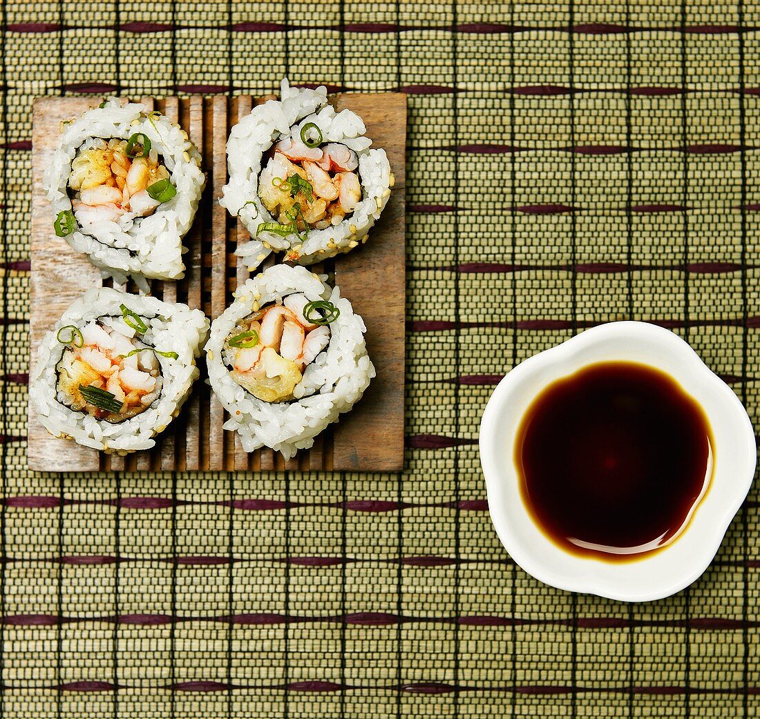 Sushi Rolls on a Plate with Bowl of Soy Sauce For Dipping