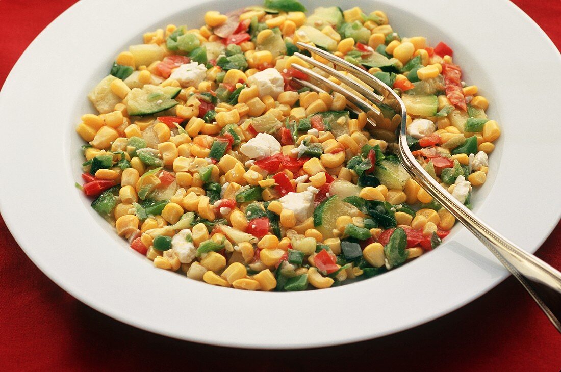 Bowl of Hot Corn Salad with a Fork