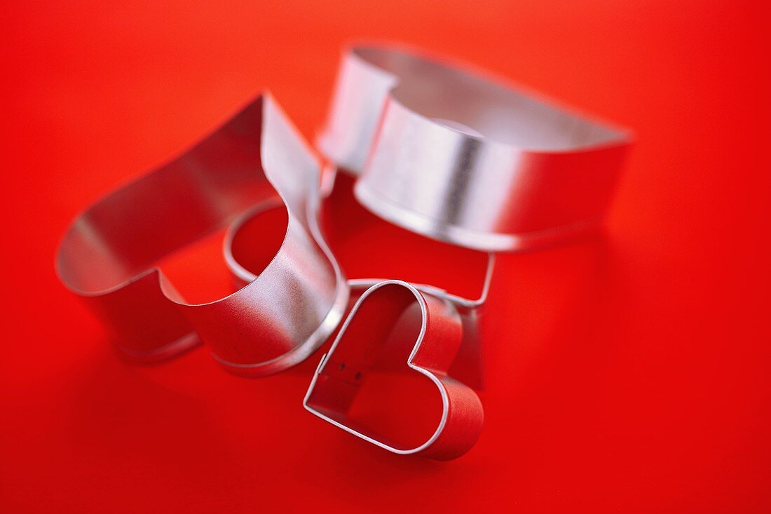 Heart Shaped Cookie Cutters on a Red Background