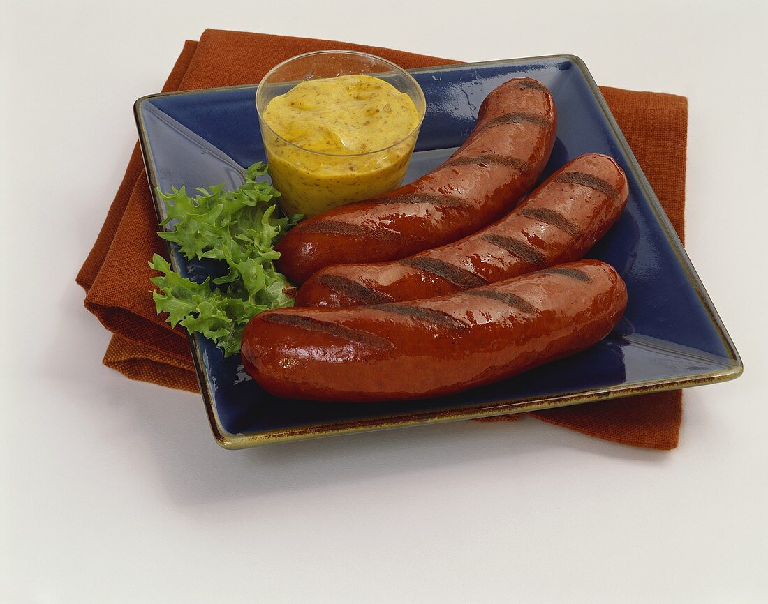 Grilled Hot Dogs with Mustard on Square Blue Plate