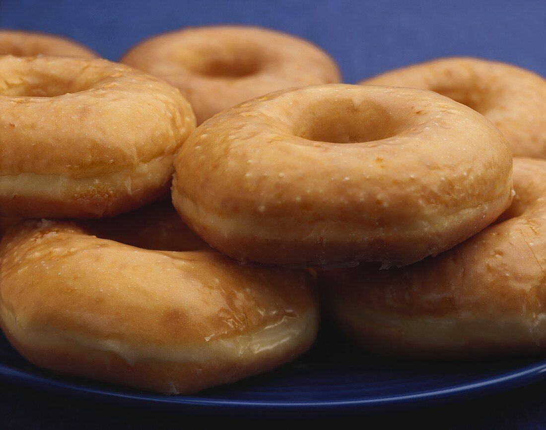 Glazed Donuts on a Blue Plate, Close Up