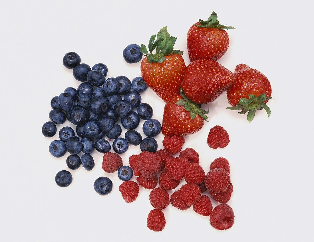 Three Piles of Berries; Blueberries, Strawberries and Raspberries