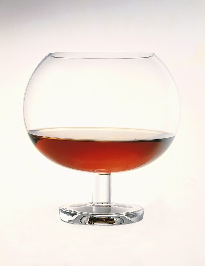 Glass of Cognac on a White Background