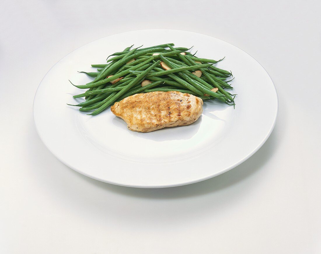 Plate with Almond Green Beans and a Chicken Breast; White Background