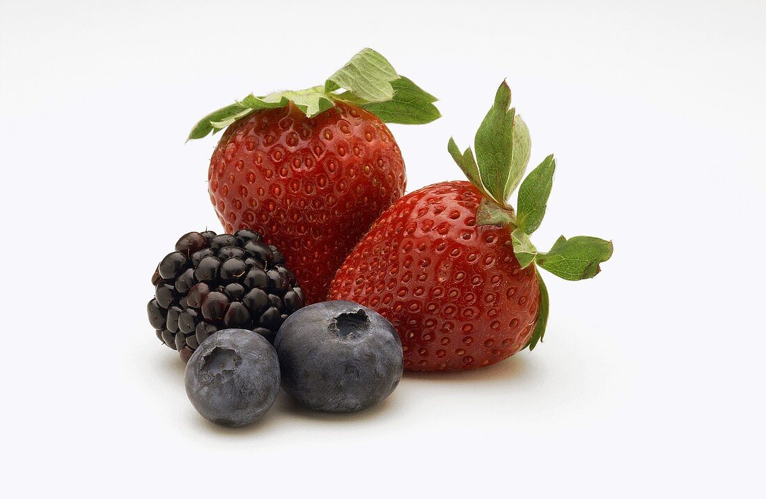 Three Assorted Berries on a White Background, Strawberries, Blueberries, Blackberries