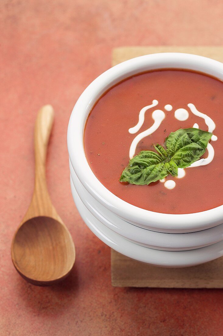 Bowl of Tomato Soup Stacked on Bowls, Wooden Spoon