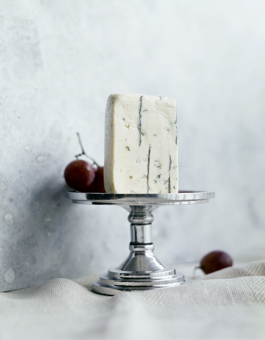 Blue Cheese on a Pedestal Dish with Red Grapes