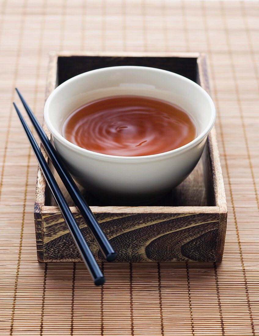 Bowl of Dipping Sauce with Chopsticks