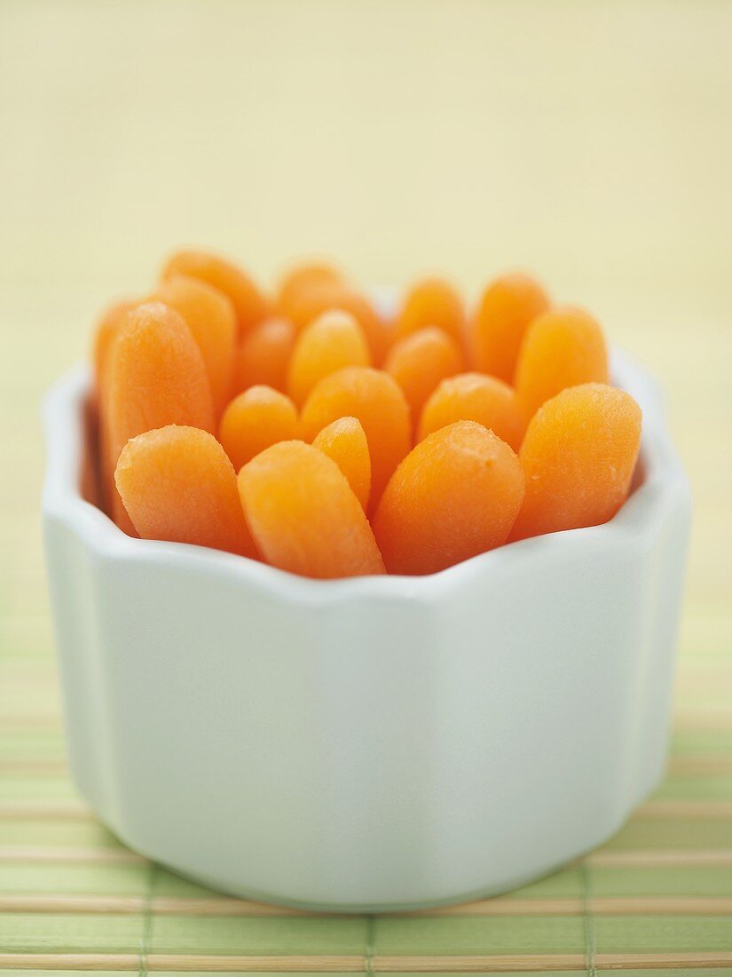 Baby Carrots Standing in a Small White Bowl