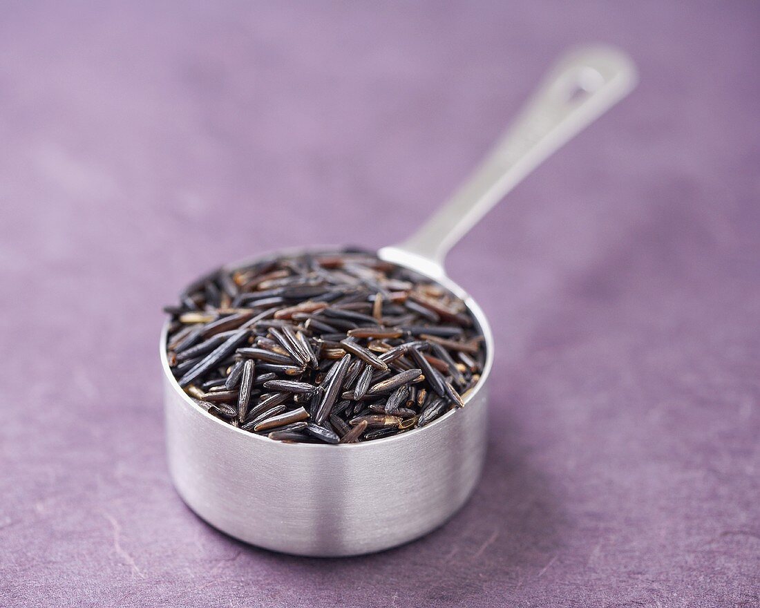 Wild Rice in a Metal Measuring Cup, Purple Background