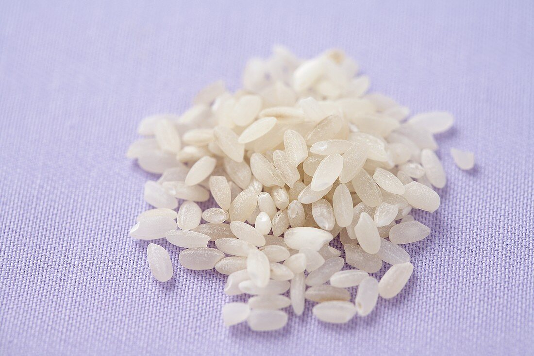 Close Up of a Small Pile of White Rice on Purple