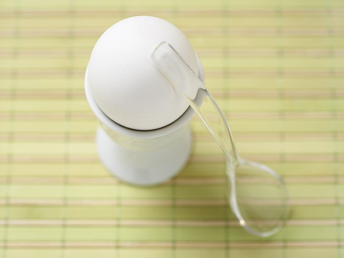 Soft Boiled Egg in an Egg Cup with a Plastic Spoon