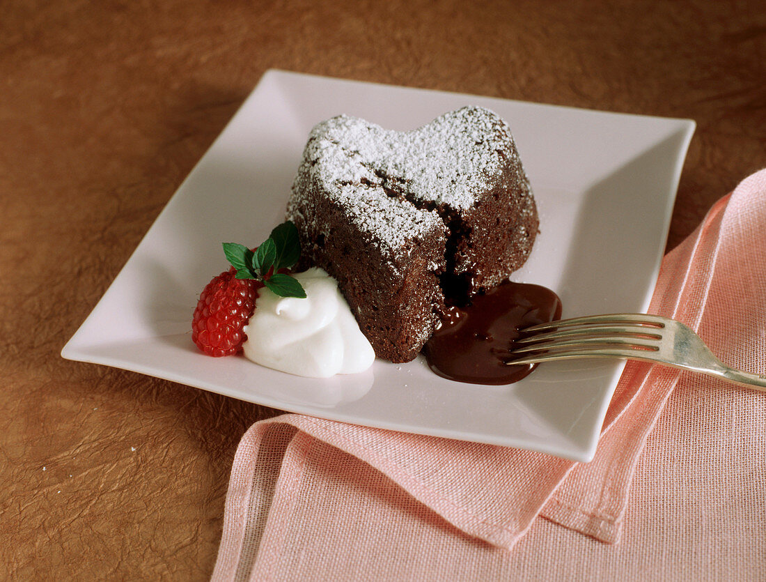Heart-shaped chocolate pudding with chocolate sauce