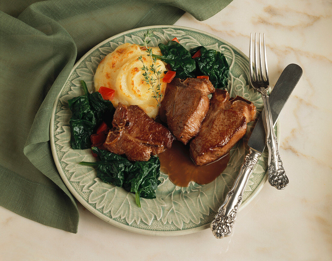 Serving of Lamb Chops with Whipped Potatoes and Spinach
