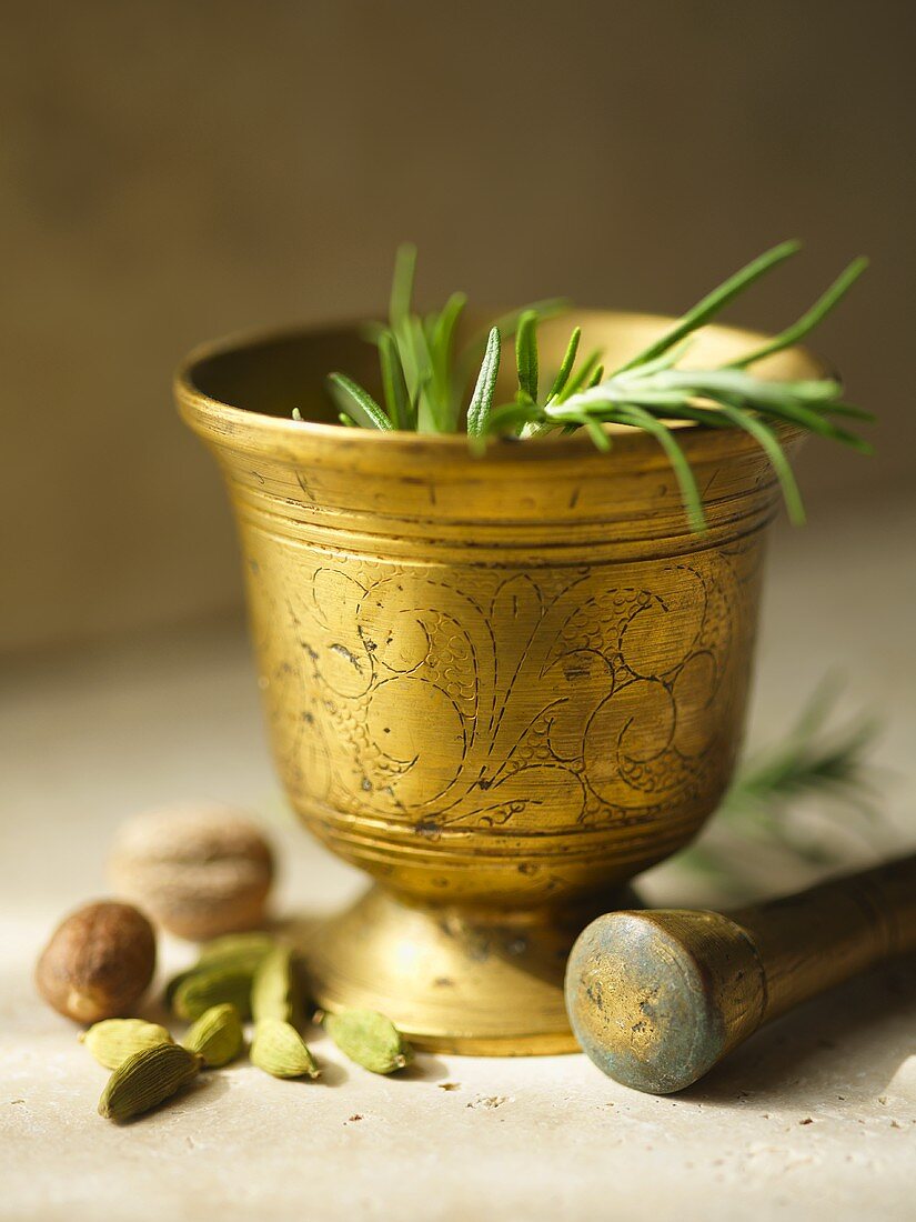 Fresh Rosemary in an Ornate Mortar with Pestle and Spices