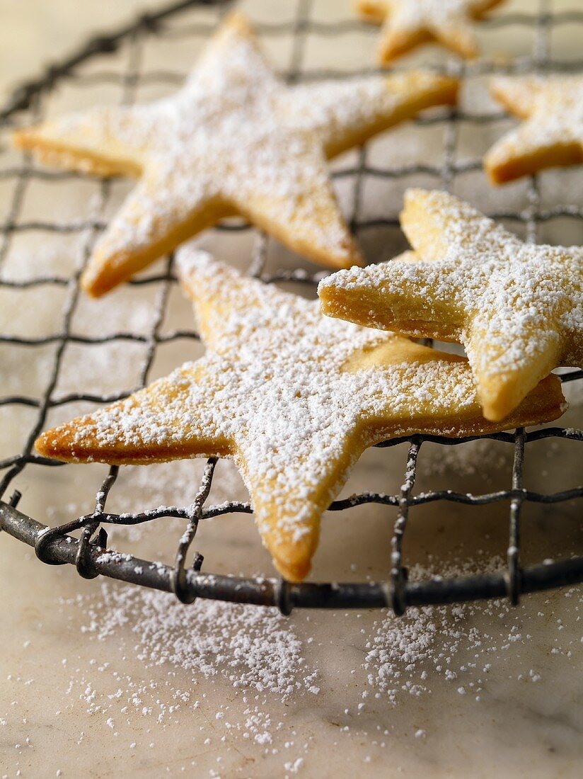 Star Cookies Sprinkled with Powdered Sugar on a Cooling Rack