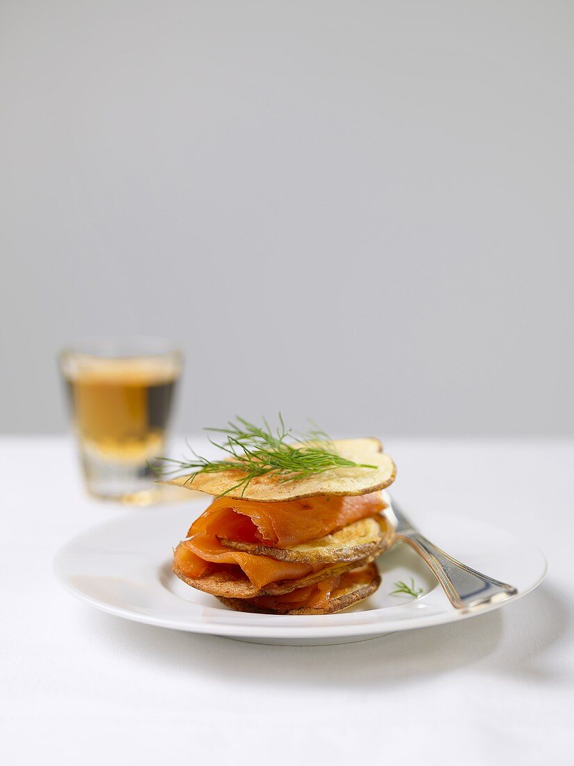 Gravlax Layered with Thinly Sliced Potatoes and Topped with Fresh Dill