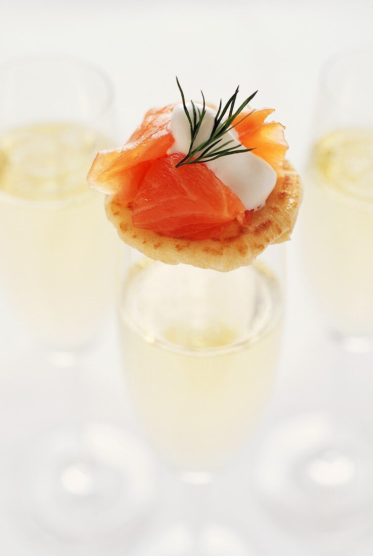 Salmon Blini on a Glass of Champagne