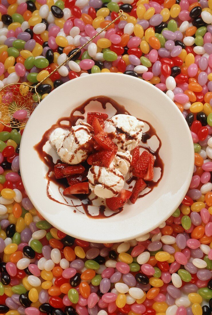 Bowl of Vanilla Ice Cream with Chocolate Sauce and Strawberries on Jelly Beans