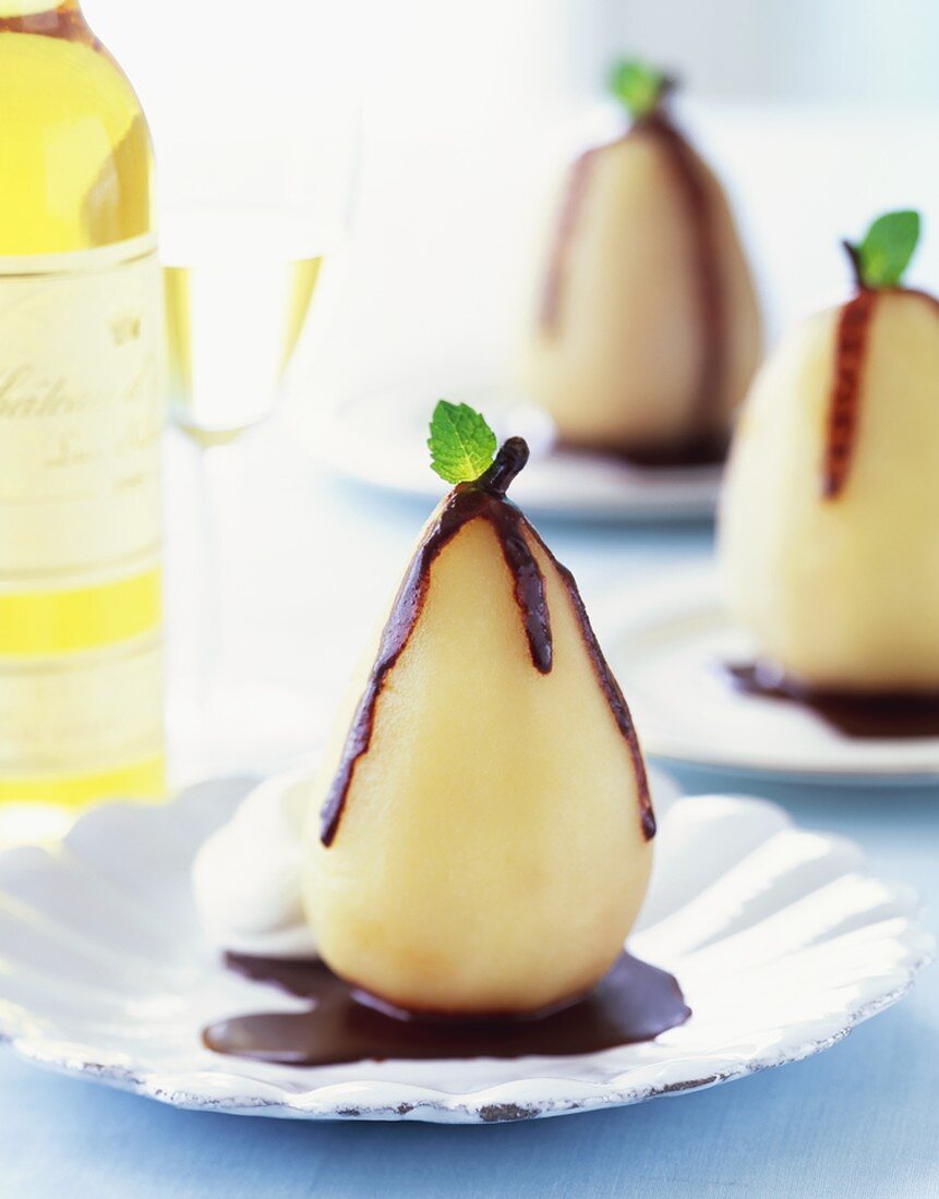 A Poached Pear in Chocolate Sauce with Mint Leaf
