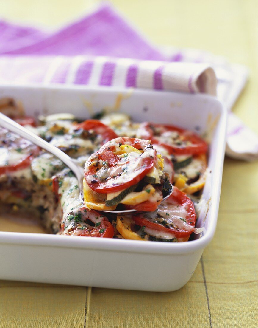 Scooping Vegetable Casserole with Tomatoes, Zucchini and Summer Squash