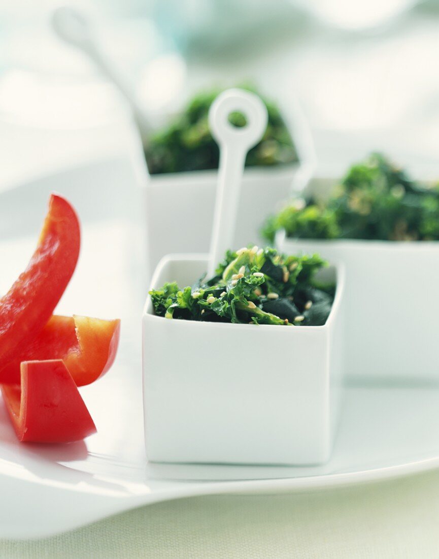 Kale and Nori Salad in Small Square Bowls with Red Pepper Strips