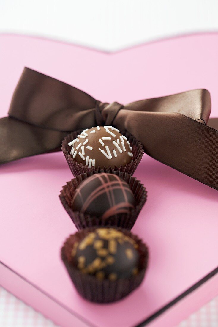 Three Gourmet Chocolate Bon Bons on Heart Shaped Box